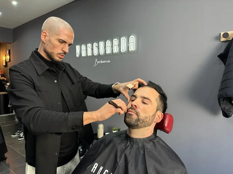 Interior da barbearia com cadeiras e espelhos